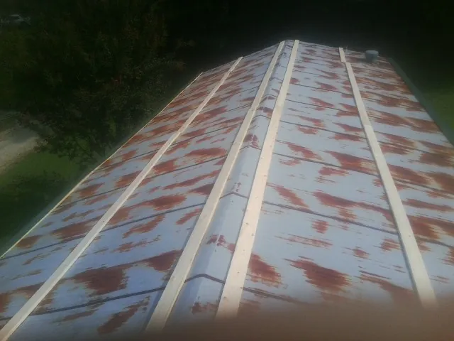 Rusted metal roof panels with new wood purlins before replacement — Storm Damage Roof Repair in Ridgeway by Roofing Brothers